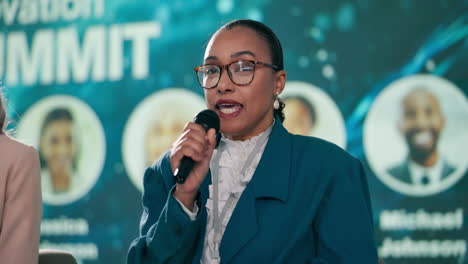 a woman speaking at a conference