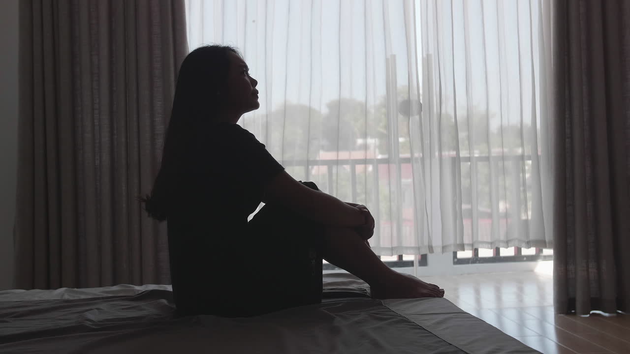 Depressed Women Sitting On The Bed