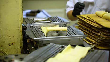 a mechanical pancake machine operated by a woman