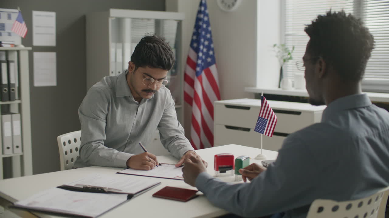 Indian Visa Applicant Filling Out Documents in American Embassy