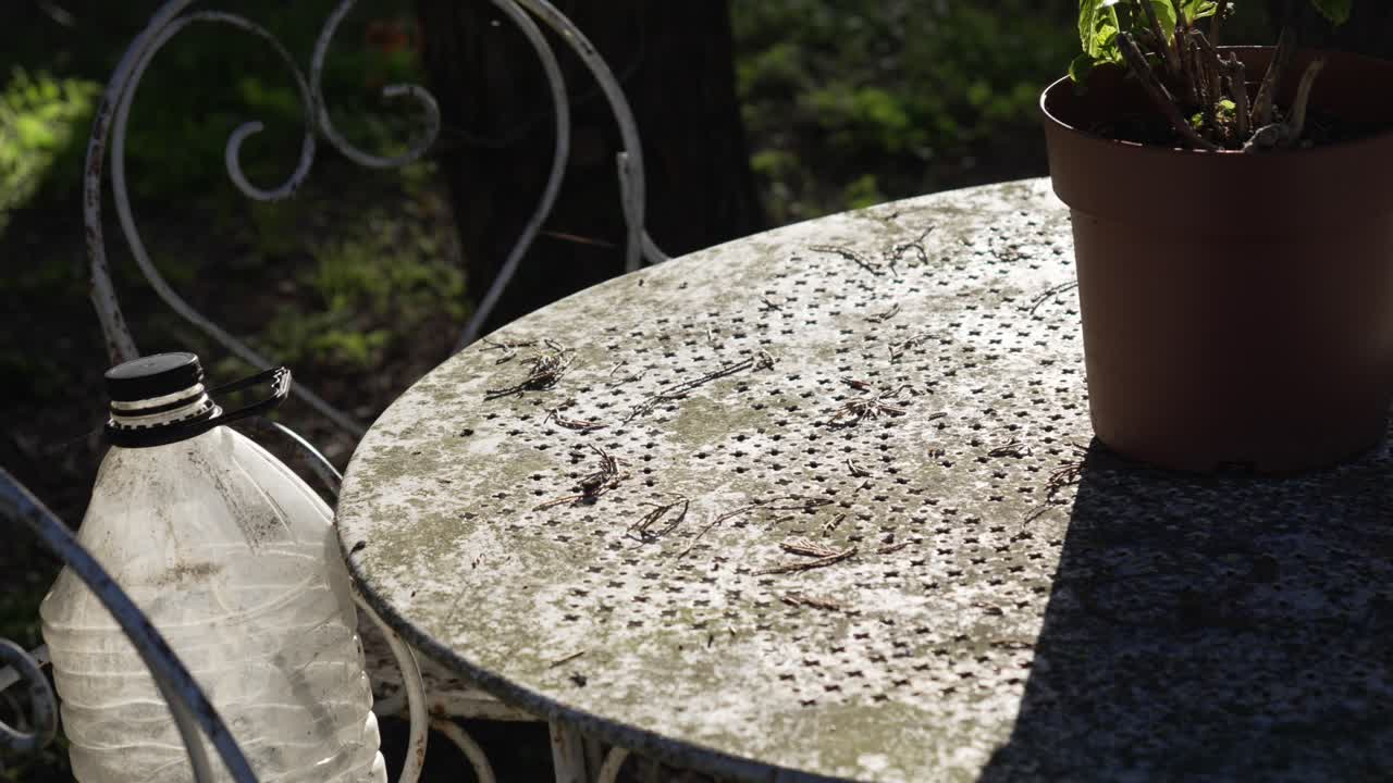 Old dirty garden outdoor table and chair, steel metal patio set dusty