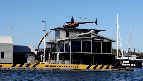 helicopter landing on a boat's helipad in gold coast