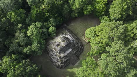 flying above famous yaxha maya ruins in jungle of guatemala, aerial