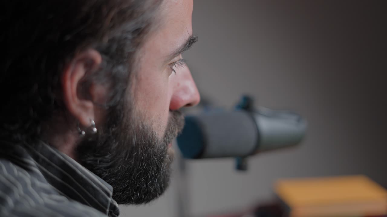 Man Speaking into Microphone in Podcast Studio