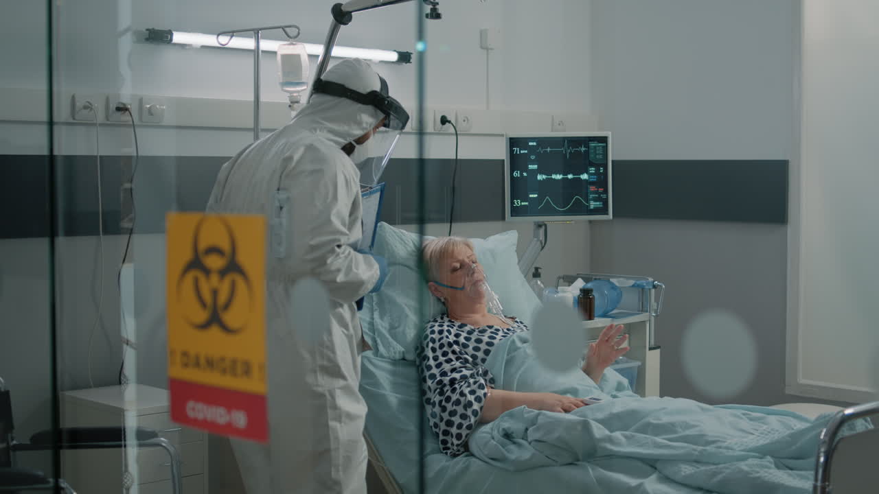 Doctor consulting woman infected with coronavirus in bed