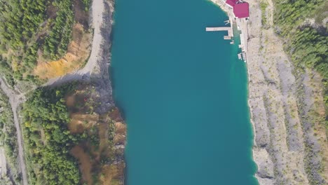 aerial view of a quarry lake with a wooden pier