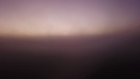 Facing-dead-tree-SLOW-RISE-UP-into-the-heavy-fog-above-the-clouds-to-see-a-haunting-sunrise