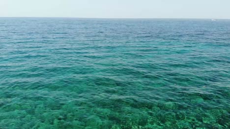 Tourist-couple-enjoying-the-beach-day,-filmed-with-a-drone