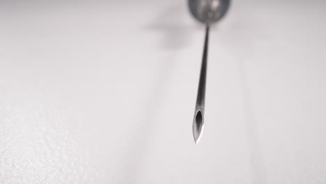 clean shiny needle of syringe on white background macro