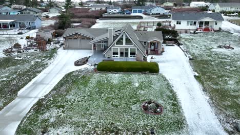 snow covered driveway and yard, a-frame cabin