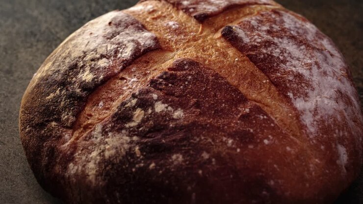 Freshly baked natural bread is on the kitchen table.
