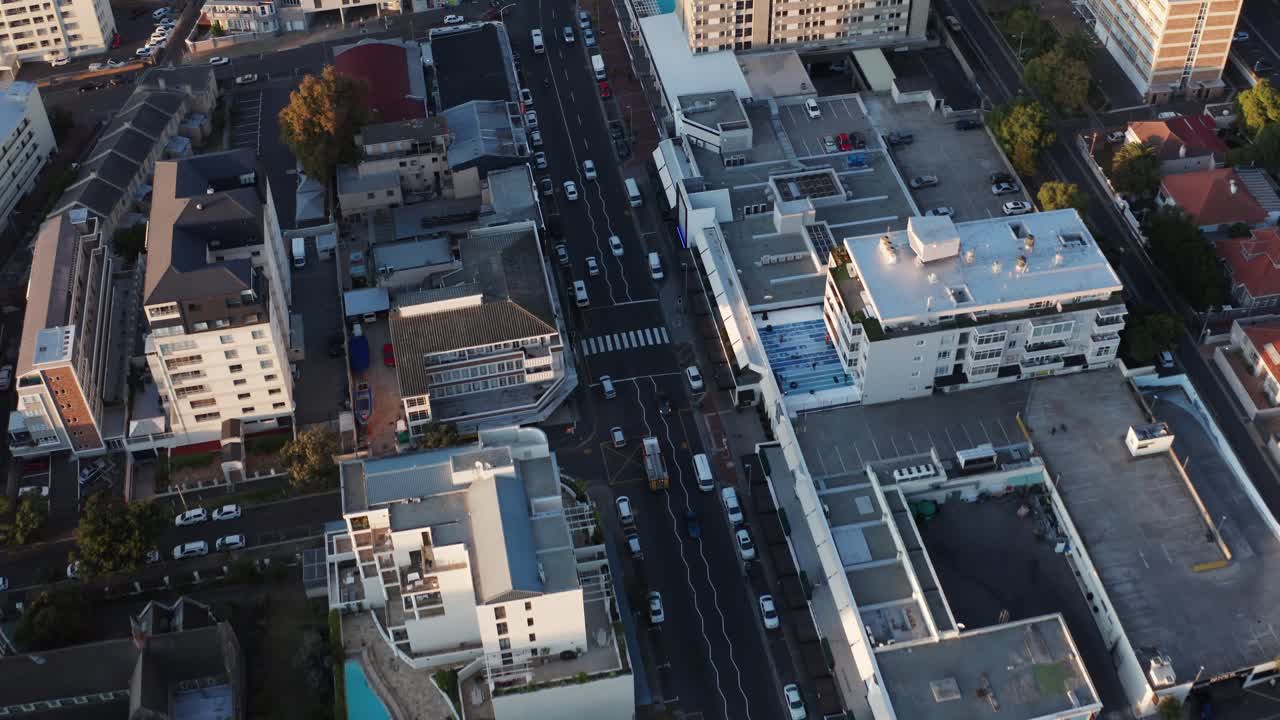 Real fire truck driving fast through city road. Emergency services and ambulance red cars with first responders. Aerial shot in Cape Town South Africa.