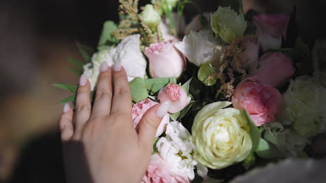 lady hand touches elegant bouquet with eustoma flowers