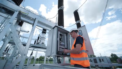 electrical engineers inspect the electrical systems at the equipment control cabinet