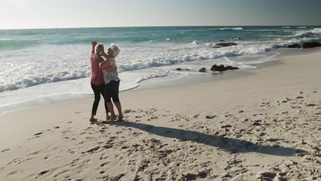 senior couple dancing together at the beach
