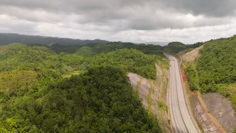drone view over jamaica's mountains: aerial views with highway 2000 toll road to the north coast sliding left