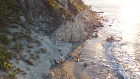 Beautiful-sunset-over-a-rocky-beach-with-the-sun-setting-in-Santa-Marta,-Colombia