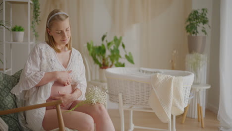 pregnant woman with baby cradle
