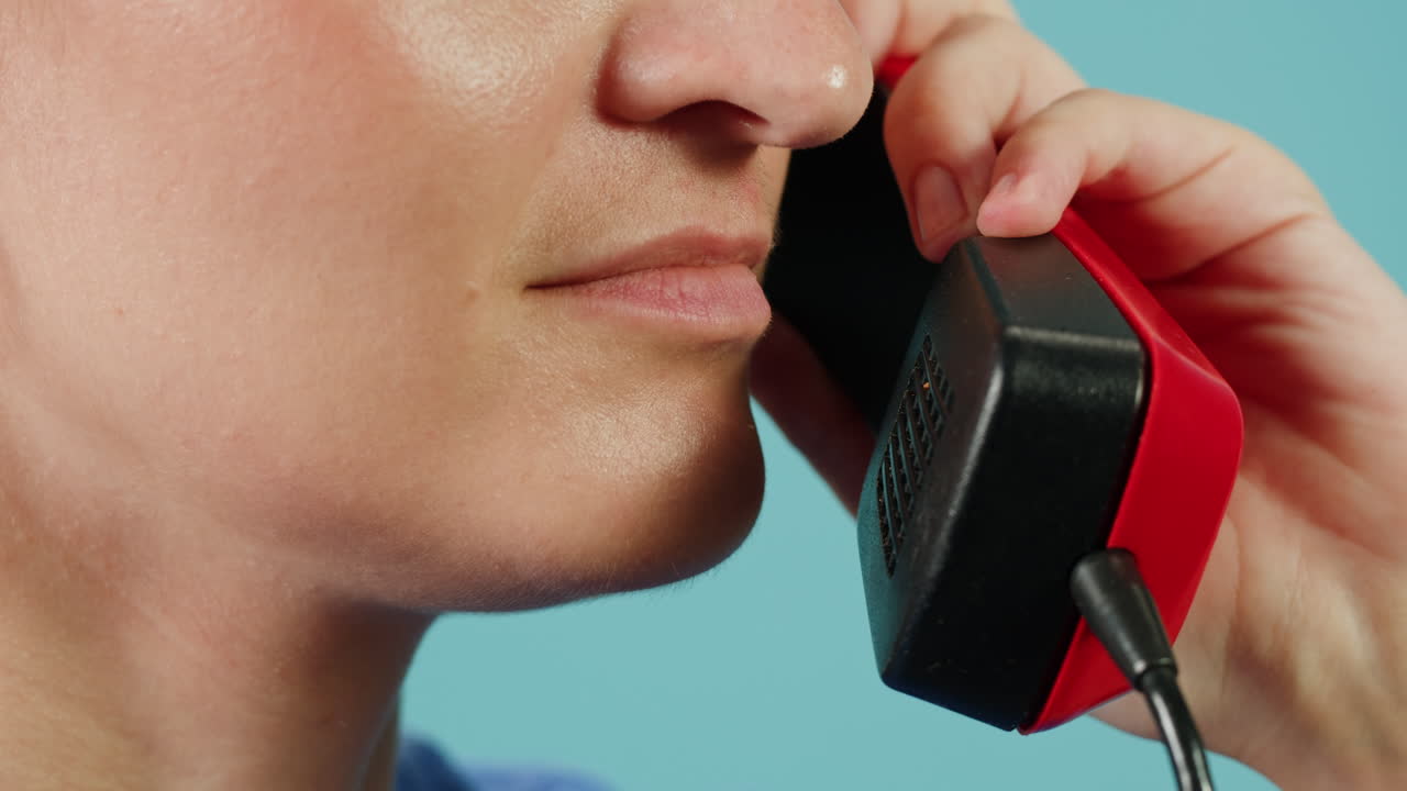 Woman Talking on a Vintage Red Telephone