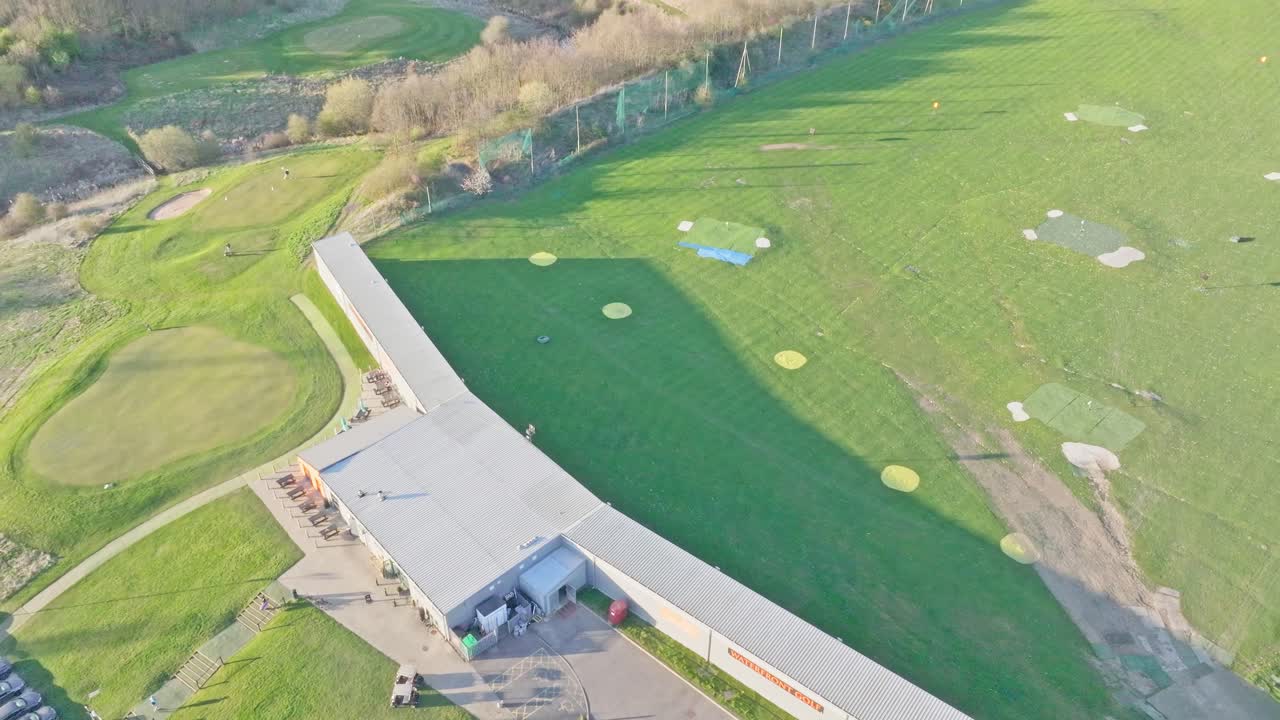 Descending aerial shot of Waterfront Golf Club driving range, Rotherham, South Yorkshire, UK