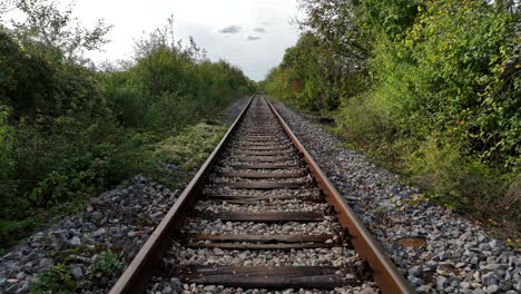 vista de la vía ferroviaria desde la parte inferior del tren, vuelo aéreo lento sobre los rieles del tren