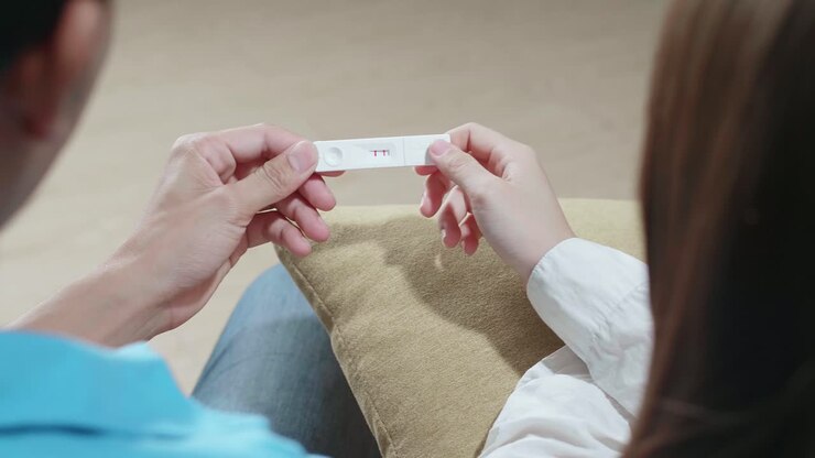 Over The Shoulder Shot Of Couple Holding Pregnancy Test, New Life And New Family Concept