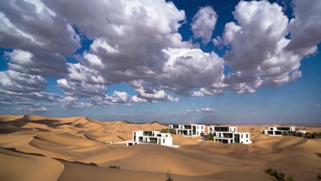 stunning modern white villas are built on the sand dunes of a desert landscape under a dramatic cloudy sky, creating a unique and luxurious retreat