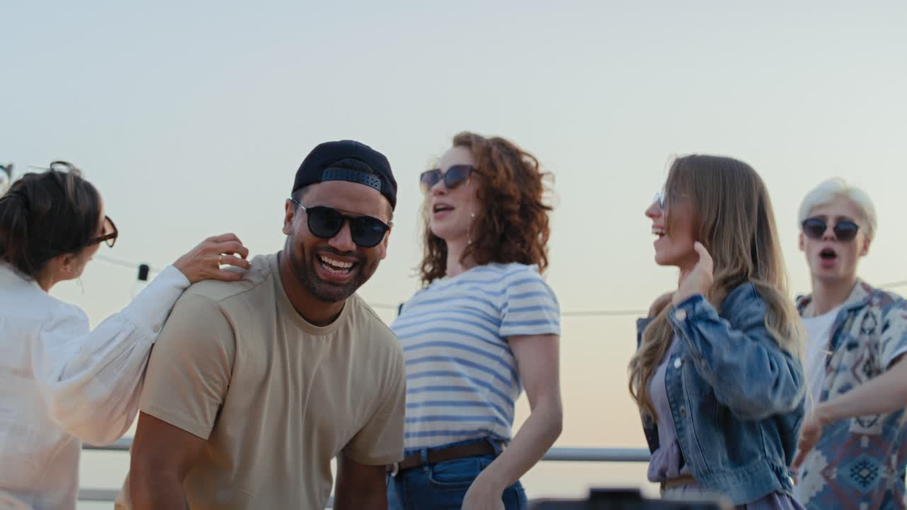 Group of friends recording viral videos at mobile phone.