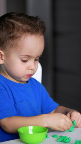 playing toys cute boy on the table. child preschool education with game. vertical video