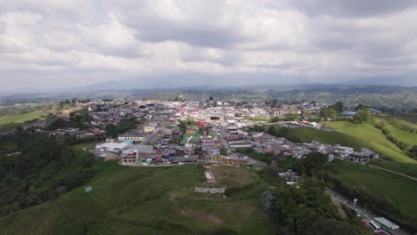 Aerial-View-Of-Filandia-Town-On-Hilltop-Surrounded-By-Green-Fields-Located-On-The-West-Side-Of-The-Cordillera-Central-of-the-Andes-mountain-range