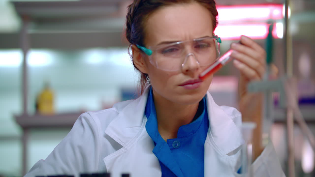 Woman chemist doing chemical test in chemistry laboratory. Chemist working