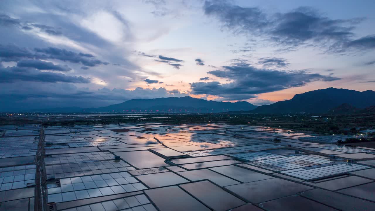 Aerial hyper lapse showing moving clouds over salt fields during golden hour. Phan Rang , Vietnam.