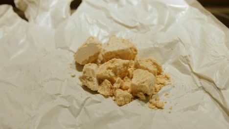 crushed fresh baker's yeast block on a white wrapper