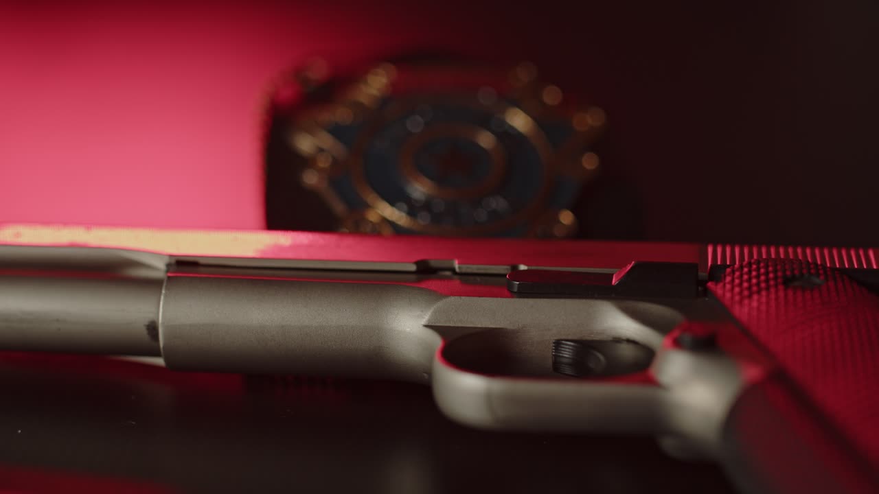 Static view of pistol with a police badge in the background
