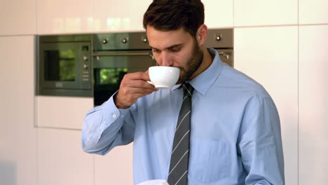 businessman reading newspaper and drinking coffee