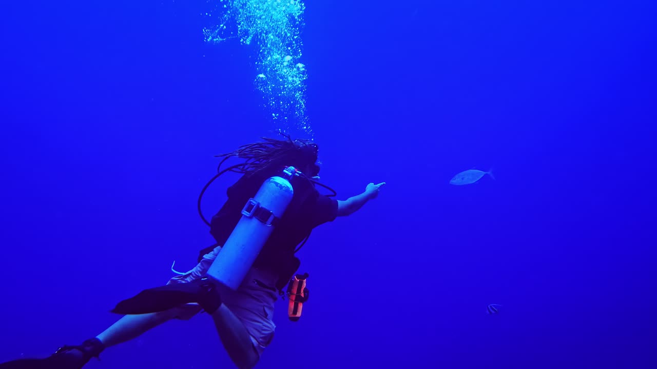 Subacqueo nell'oceano blu profondo che esplora la serenità sottomarina, in un'atmosfera calma e tranquilla