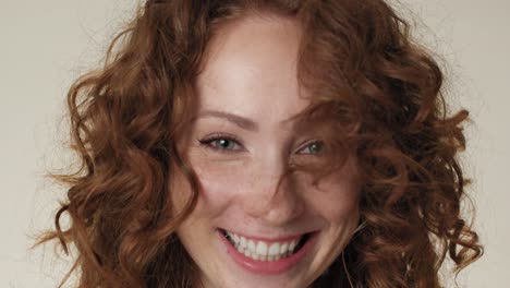 Close-up-portrait-of-cheerful-caucasian-red-head-woman-in-underwear-in-the-studio.