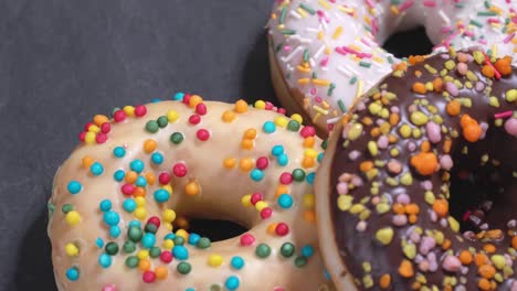 sweet donuts spinning on a dark background. traditional american sweetness