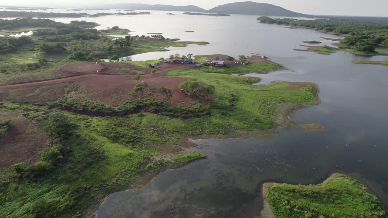 breathtaking shot from a drone dollying in over the San Francisco de Tiznados reservoir, capturing the serene, untouched beauty of the landscape at sunrise