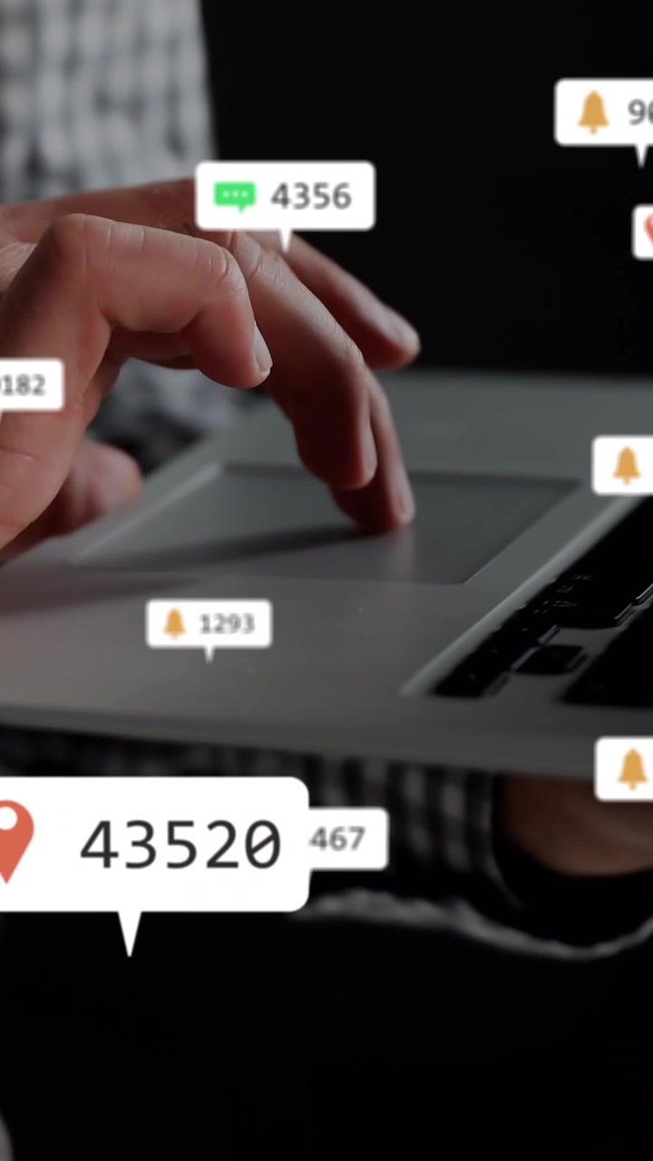 Animation of icons and changing numbers, midsection of caucasian man using laptop