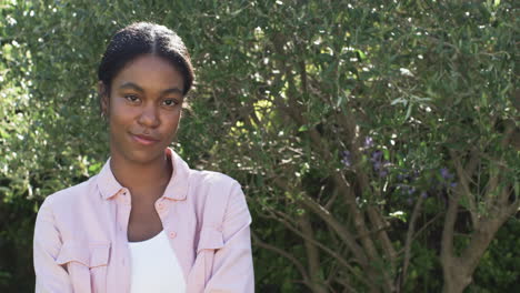 A-young-African-American-woman-smiles-gently-outdoors-with-copy-space