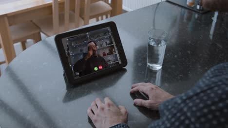 socially isolated christmas two guys speaking to camera on videocall with overlay toasting with a cup