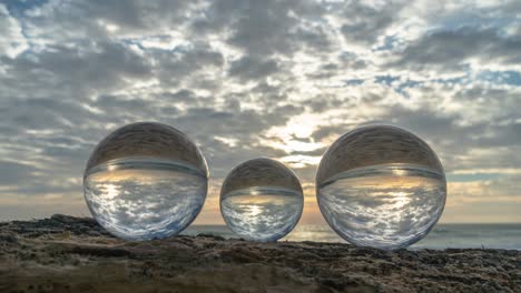 view of the beach in sunset inside crystal balls.