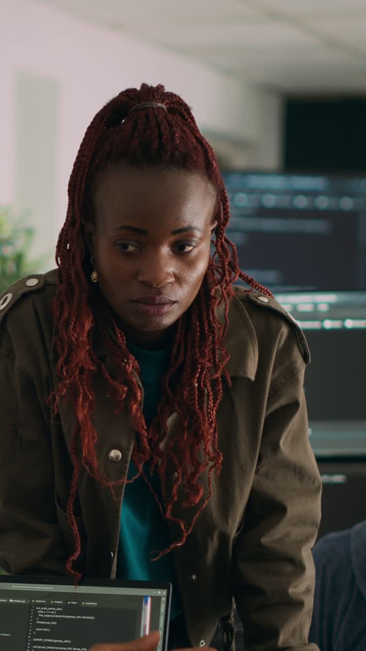 Vertical video: Software engineers analyzing source code and database