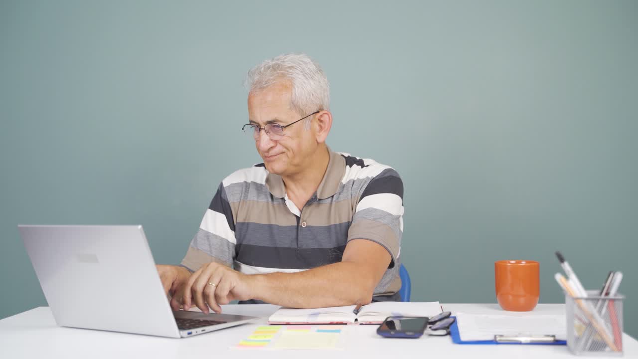 Negative expression of man using laptop.