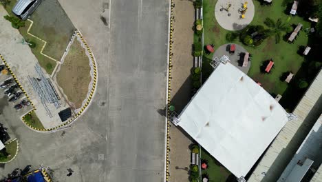 top down aerial view of virac town center with paved road, people interacting, and picnic area