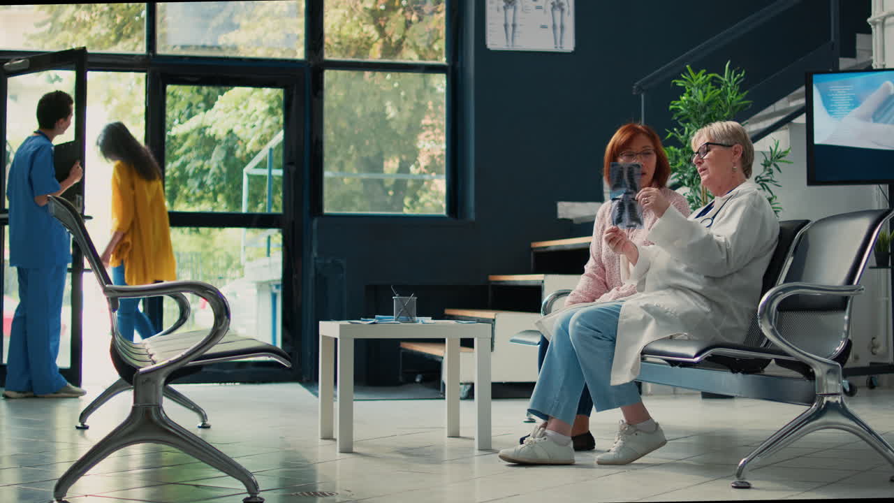 Doctor reviewing x-ray with patient in clinic waiting room