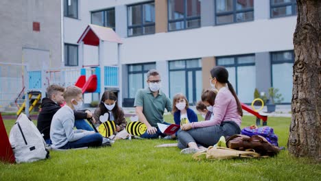 group of cheerful children learning outdoors at school after covid-19 quarantine and lockdown.