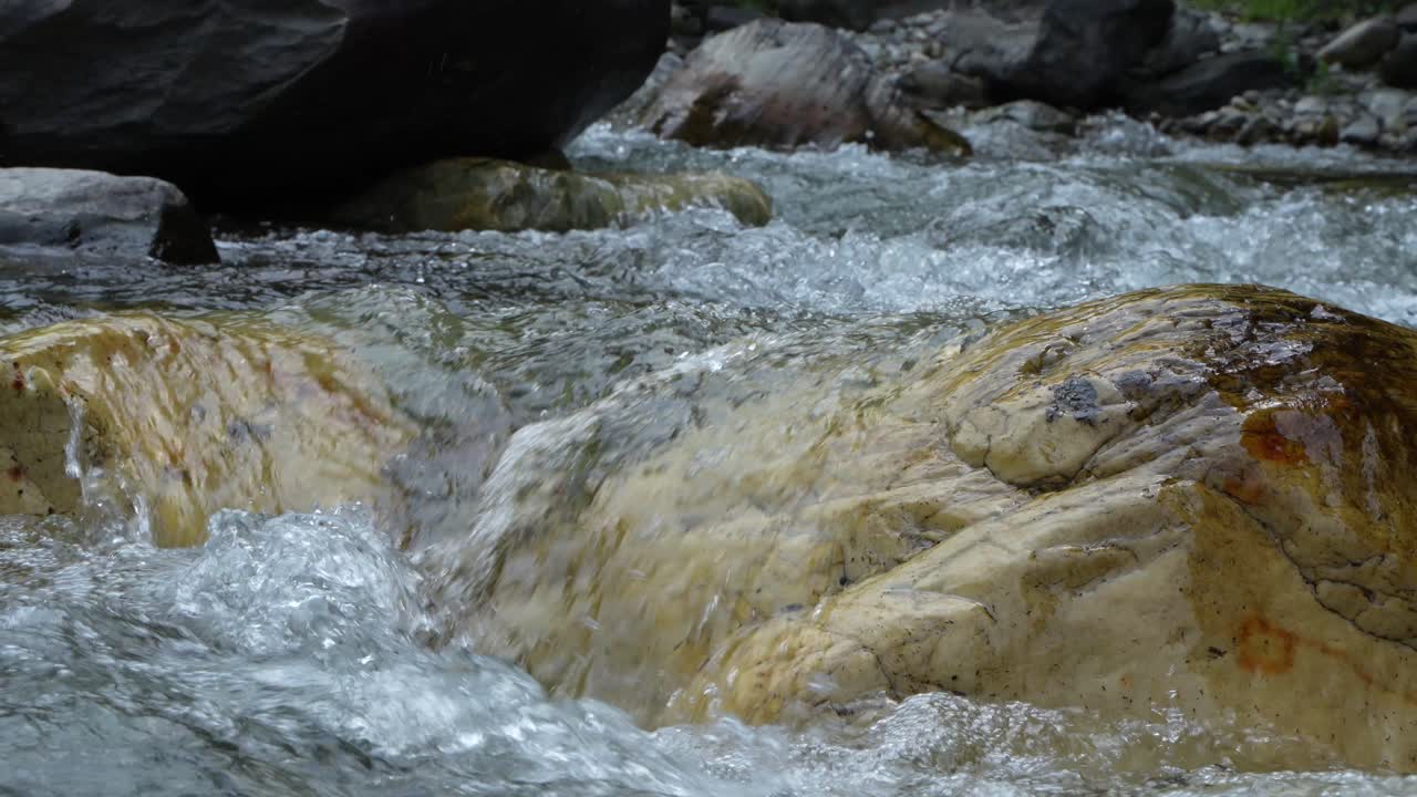 Water is flowing through a mountain torrential river.