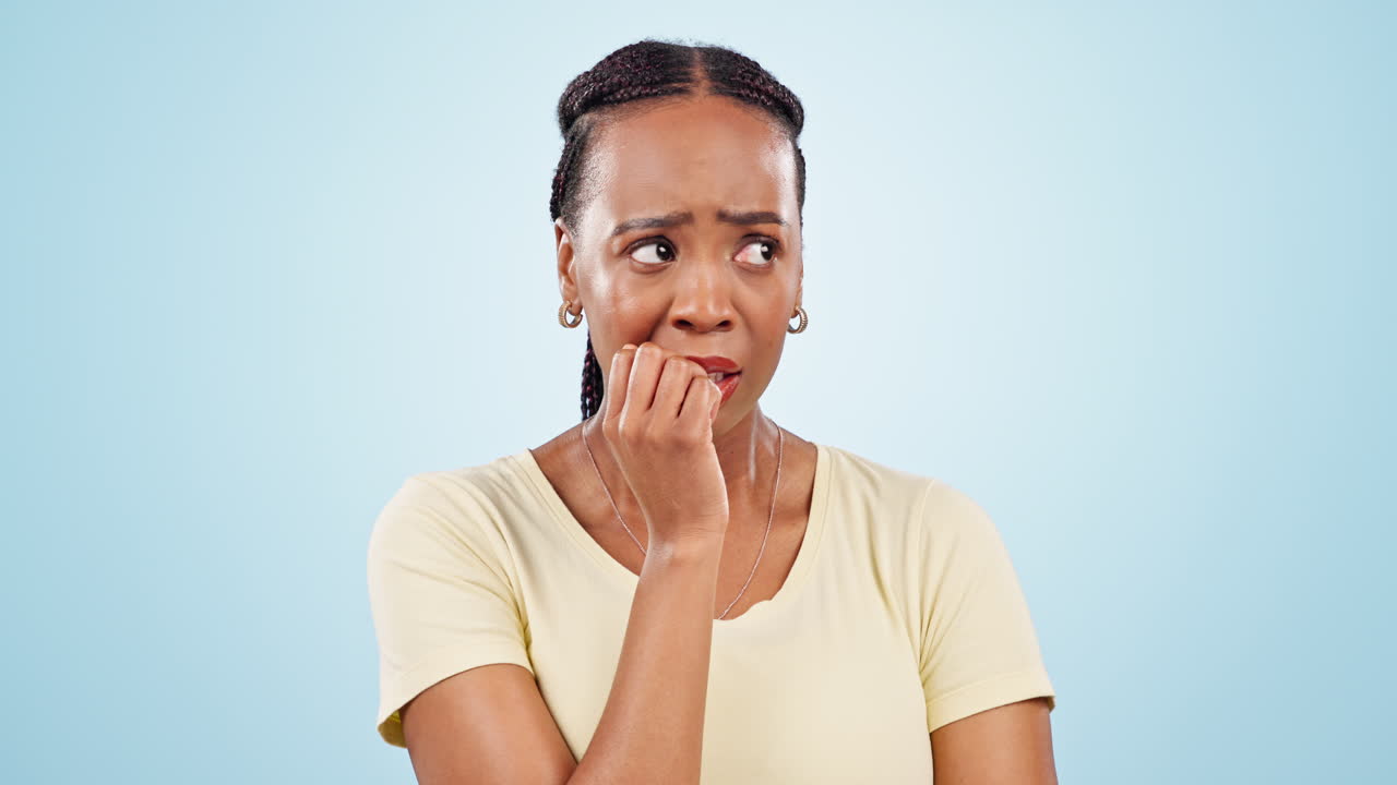 Woman, studio and biting nails with anxiety